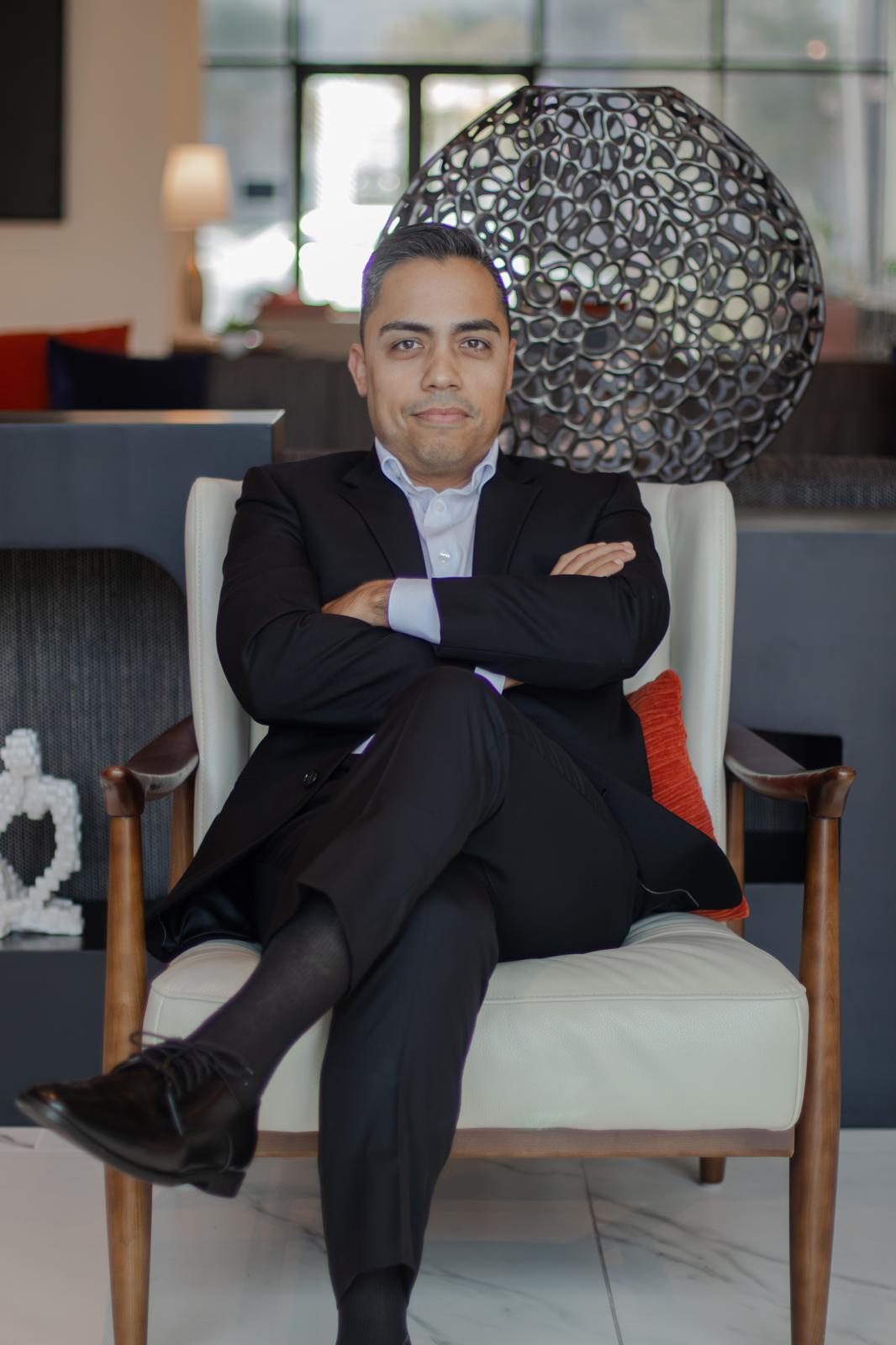Eric seated with his arms folded